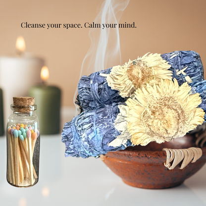 Decorative setup with flowers, matches, and candles on a table.