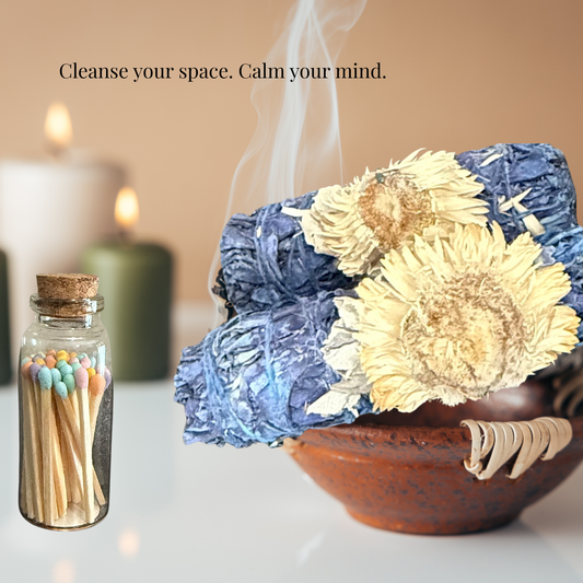 Decorative setup with flowers, matches, and candles on a table.