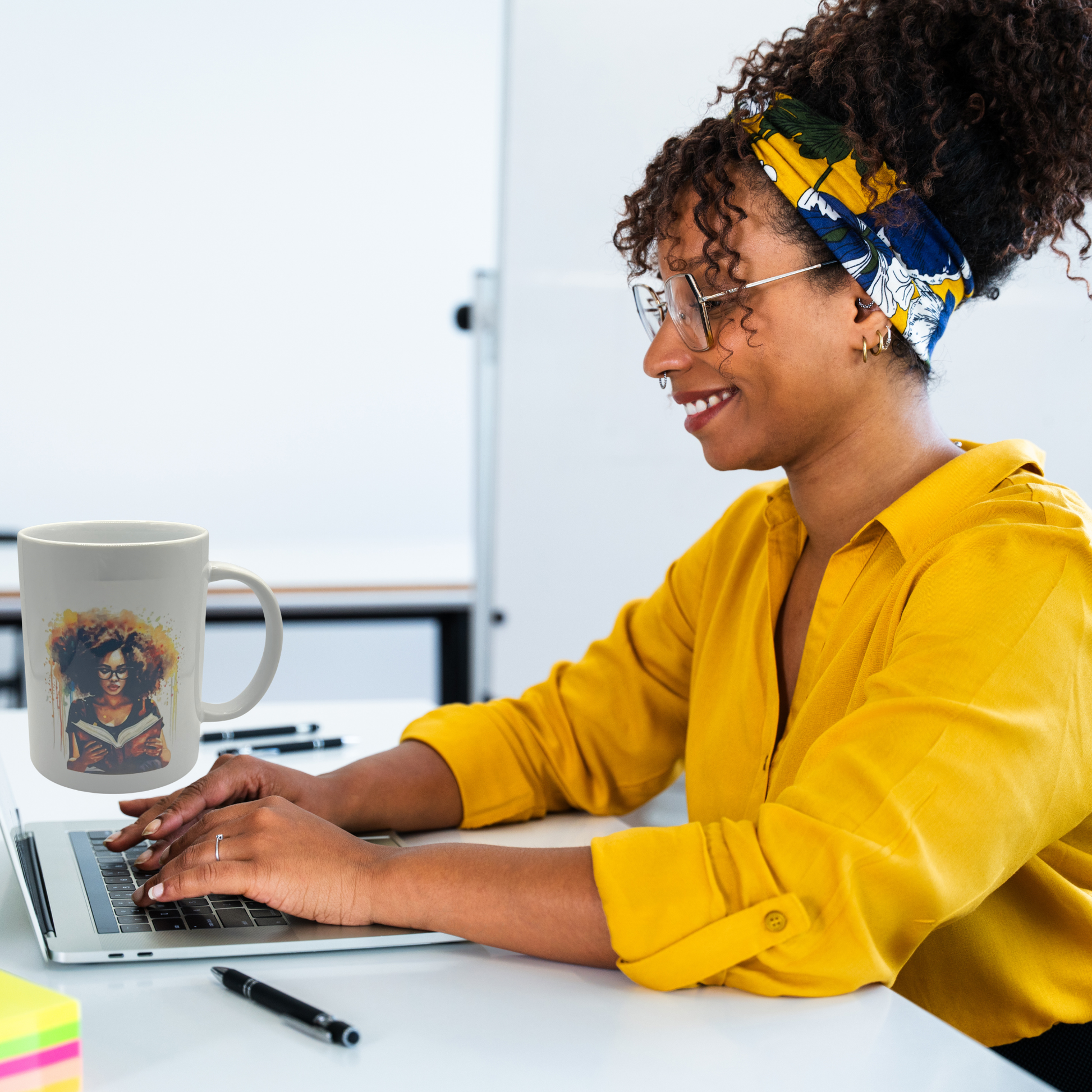 Woman in yellow shirt using laptop with mug and notepad on desk