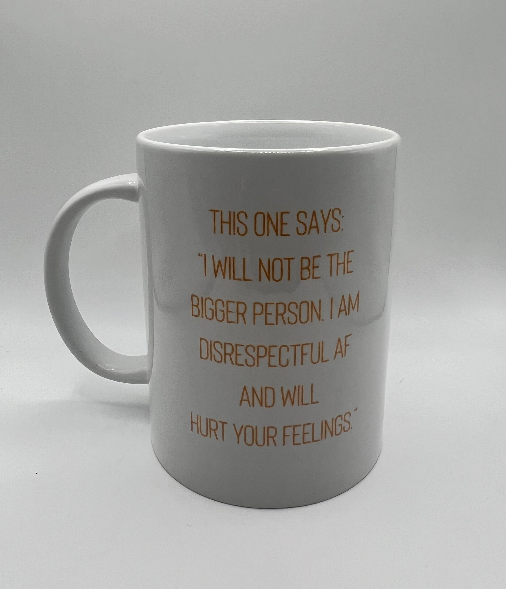White mug with brown text on a gray background