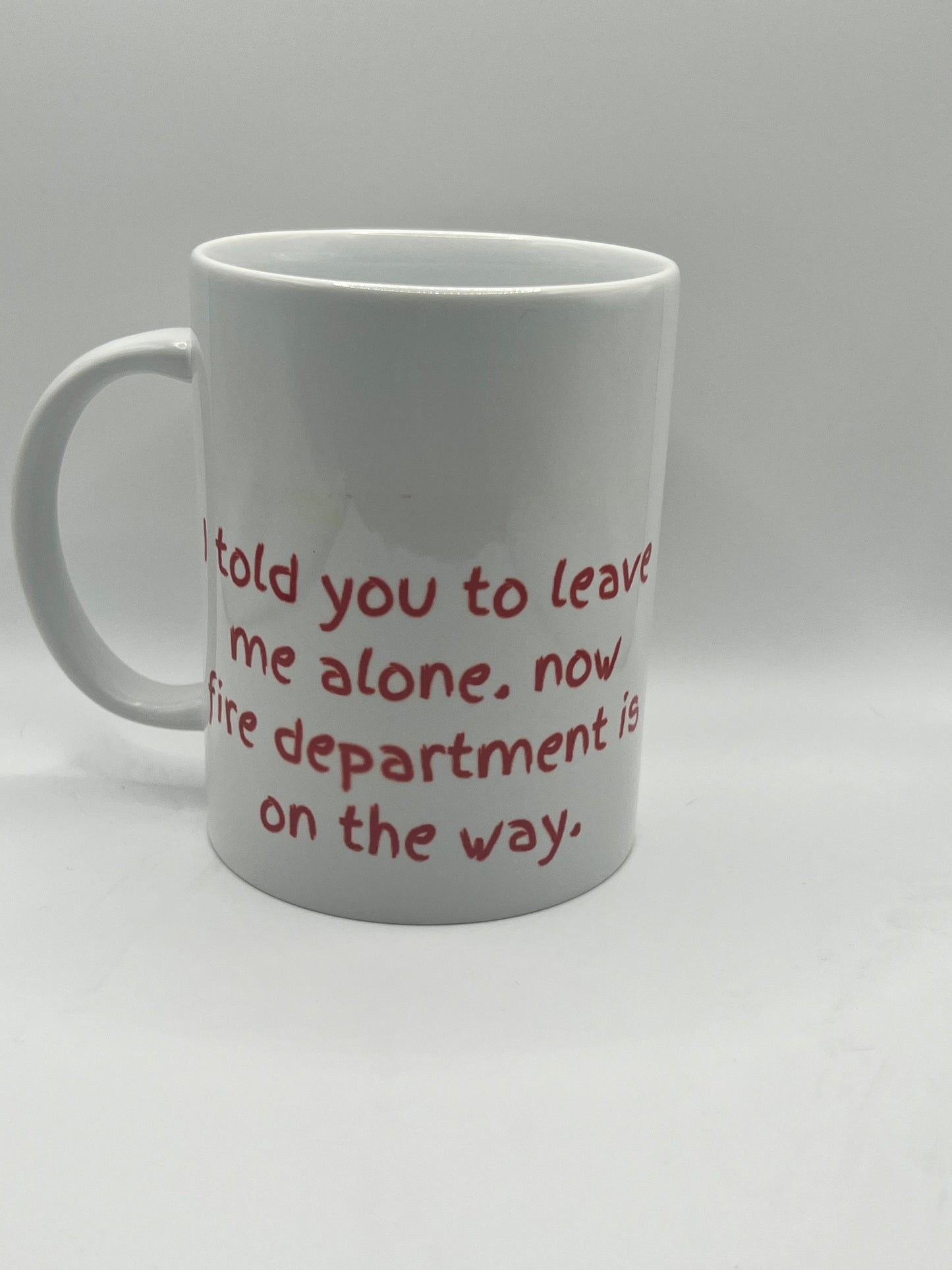 White mug with red text on a white background